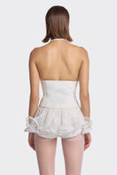 White MS. Pleat corset top by Stolen Stores, featuring pleated design and structured fit, displayed on a neutral background.