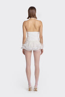White MS. Pleat corset top by Stolen Stores featuring pleated design and structured fit, displayed on a beige mannequin.