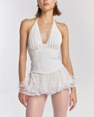 White MS. Pleat corset top by Stolen Stores displayed on a model, showcasing its structured design and pleated details.