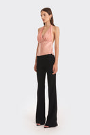 Stolen Stores Ms. Pleat Peach Top featuring pleated design and vibrant papaya color, styled as a fashionable women's top.
