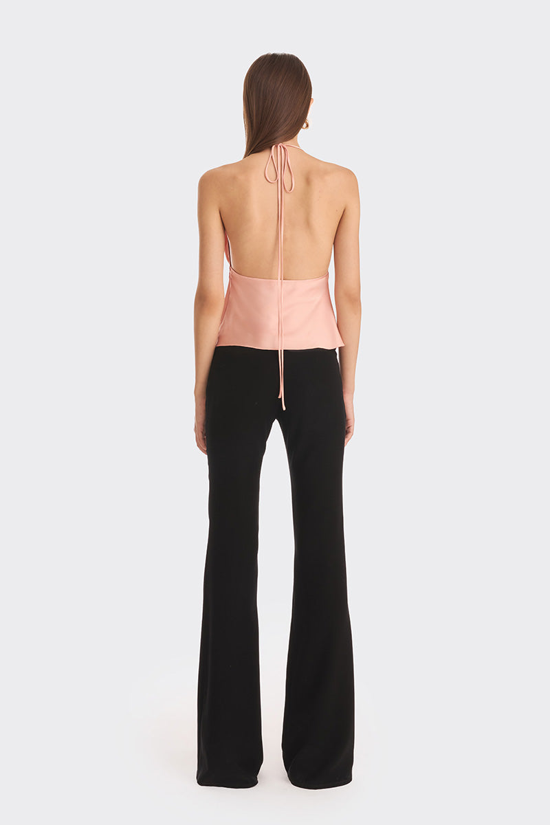 Stolen Stores Ms. Pleat Peach Top featuring soft pleats and a relaxed fit, shown in a vibrant papaya color.