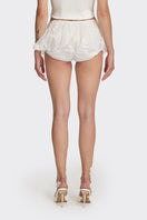 White mini skirt from Stolen Stores' MS. TUTU collection, showcasing a stylish, fitted design with a smooth fabric finish.