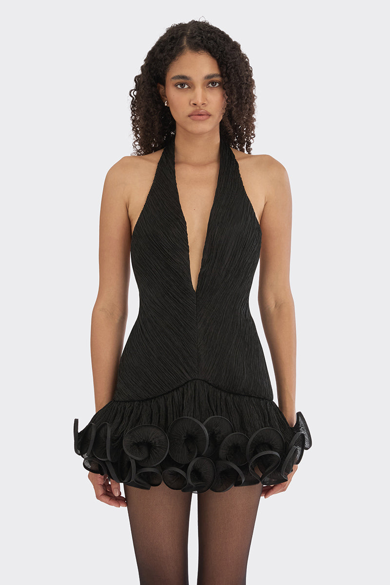 Black MS. Tutu V-neck mini dress by Stolen Stores, shown on a model, highlighting its sleek design and V-neck detail.