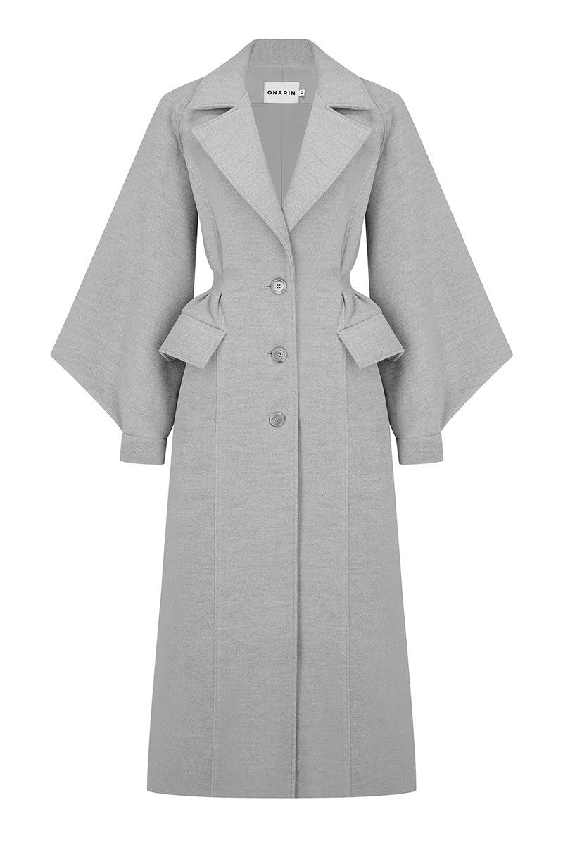 Gray wool coat for women from Stolen Stores' Ms. Doll collection, shown hanging on a wooden hanger.