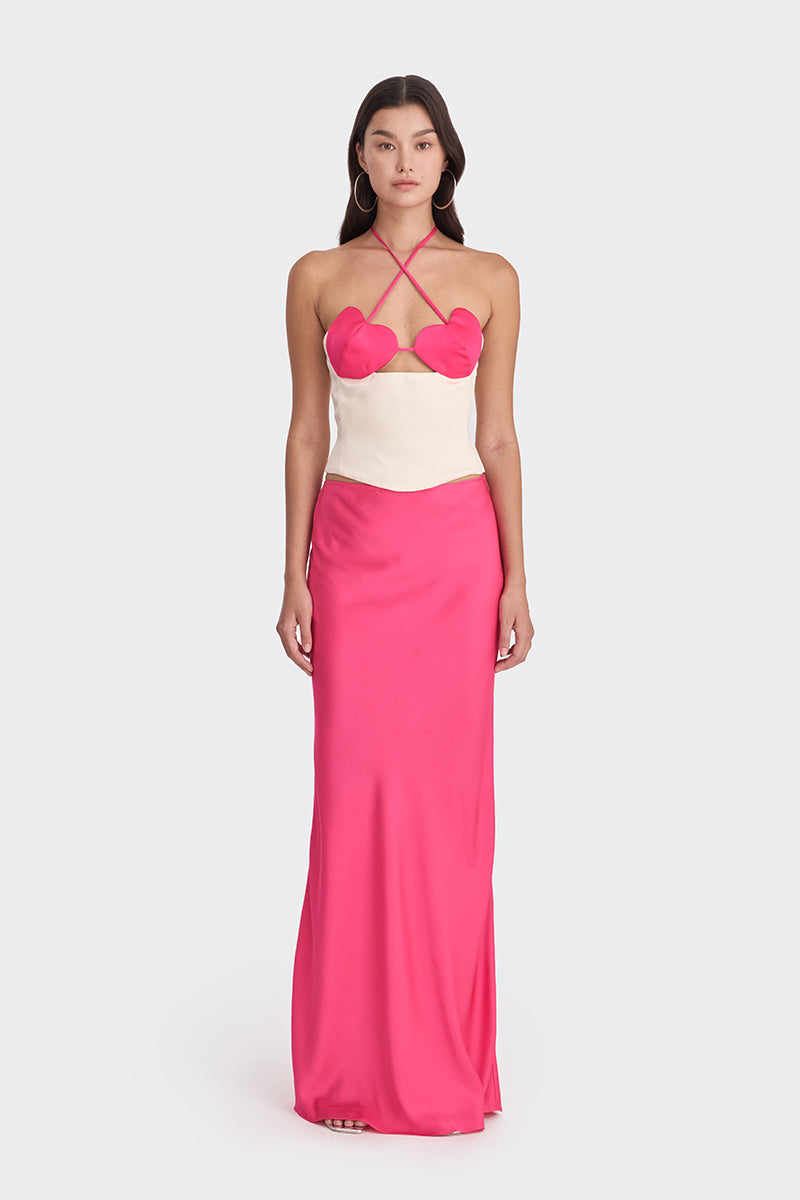 Hot pink and beige bustier top by Stolen Stores featuring a two-tone design and heart detail, styled on a model.