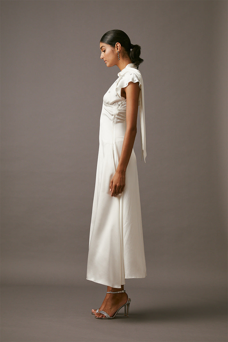 Elegant MUMTAAZ embellished maxi dress in pearl by MASTANI, featuring intricate beadwork and flowing fabric.