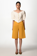 Liya mustard Bermuda shorts with a relaxed fit, front pockets, and a casual style perfect for summer wear.