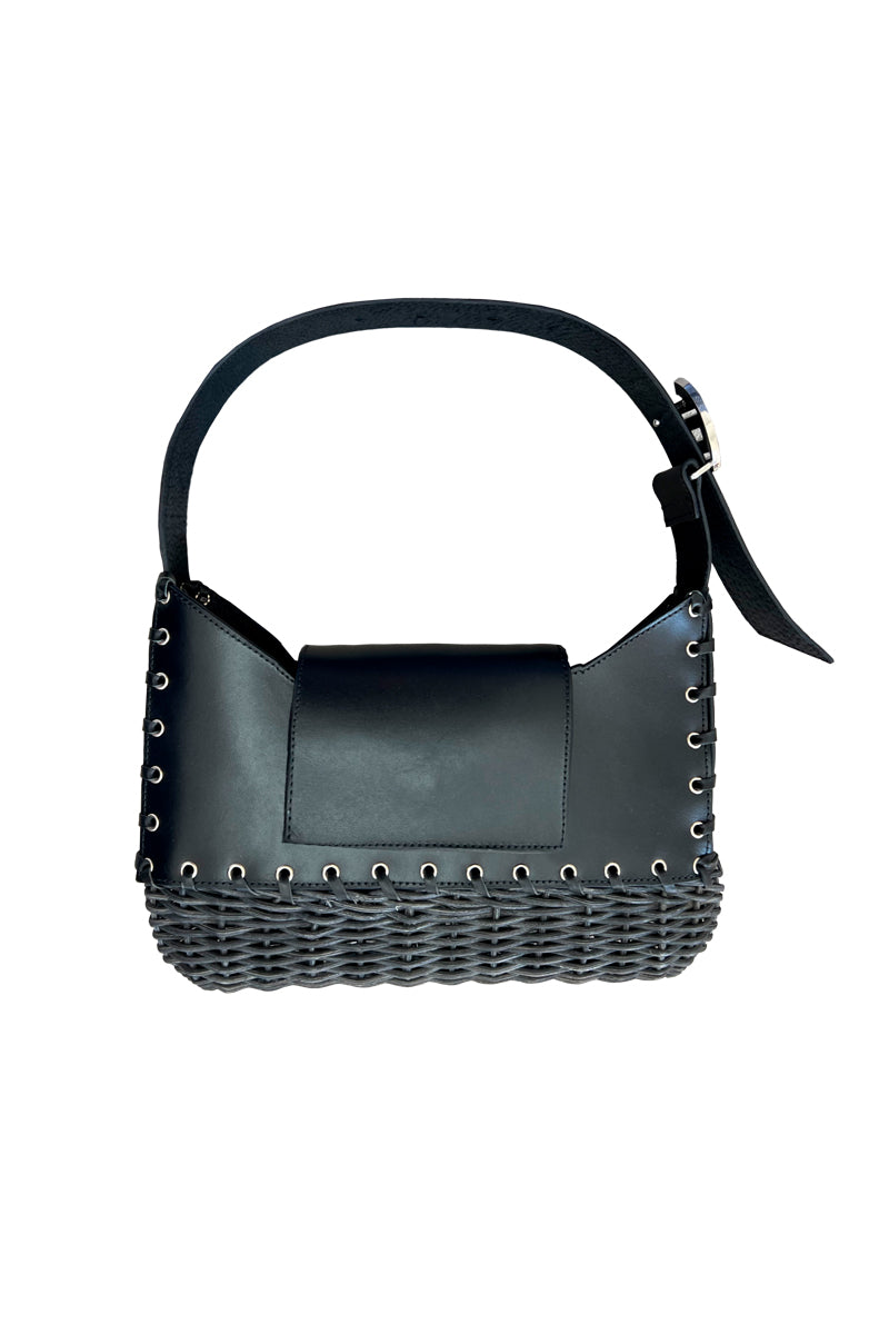 JC Pajares NAHI wicker and leather top handle bag with woven wicker body and leather accents on a white background.