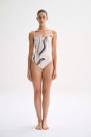 Nelblu Tierra One-Piece Swimsuit displayed on a hanger, featuring a stylish design and vibrant color suitable for swimwear.