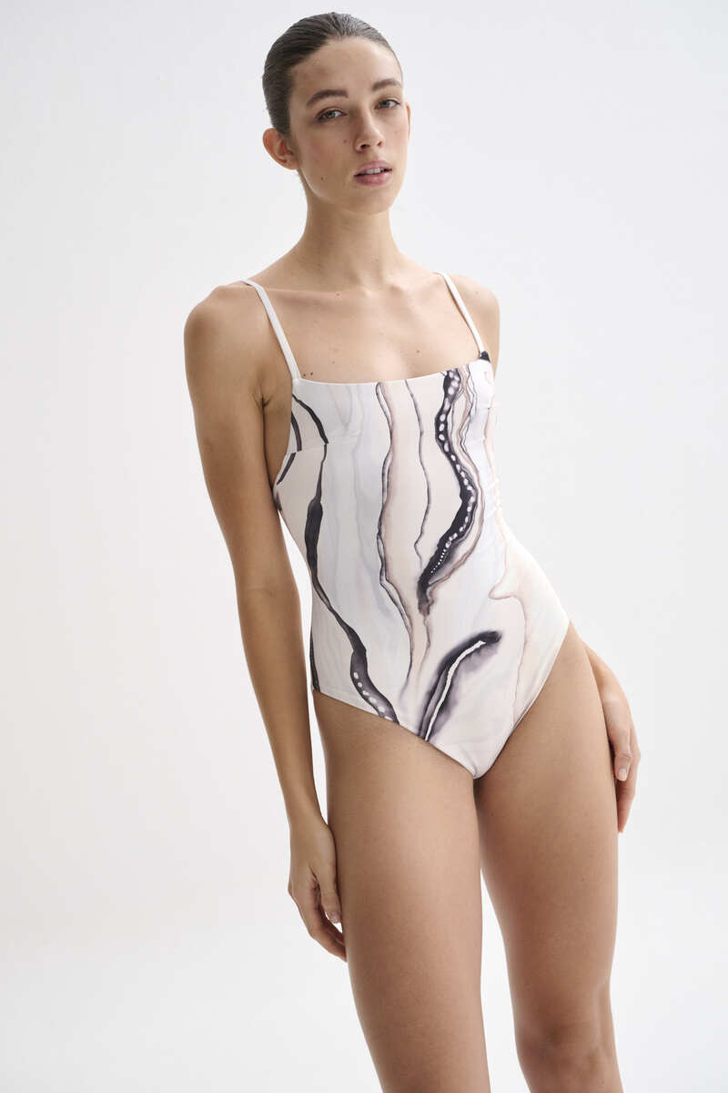 Nelblu Tierra One-Piece Swimsuit with colorful tropical print, featuring a flattering cut and adjustable straps.