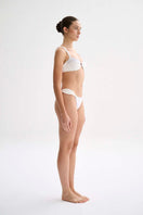 Nelblu Shell bikini top in white, featuring a stylish design with shell accents, perfect for beachwear and swimwear fashion.