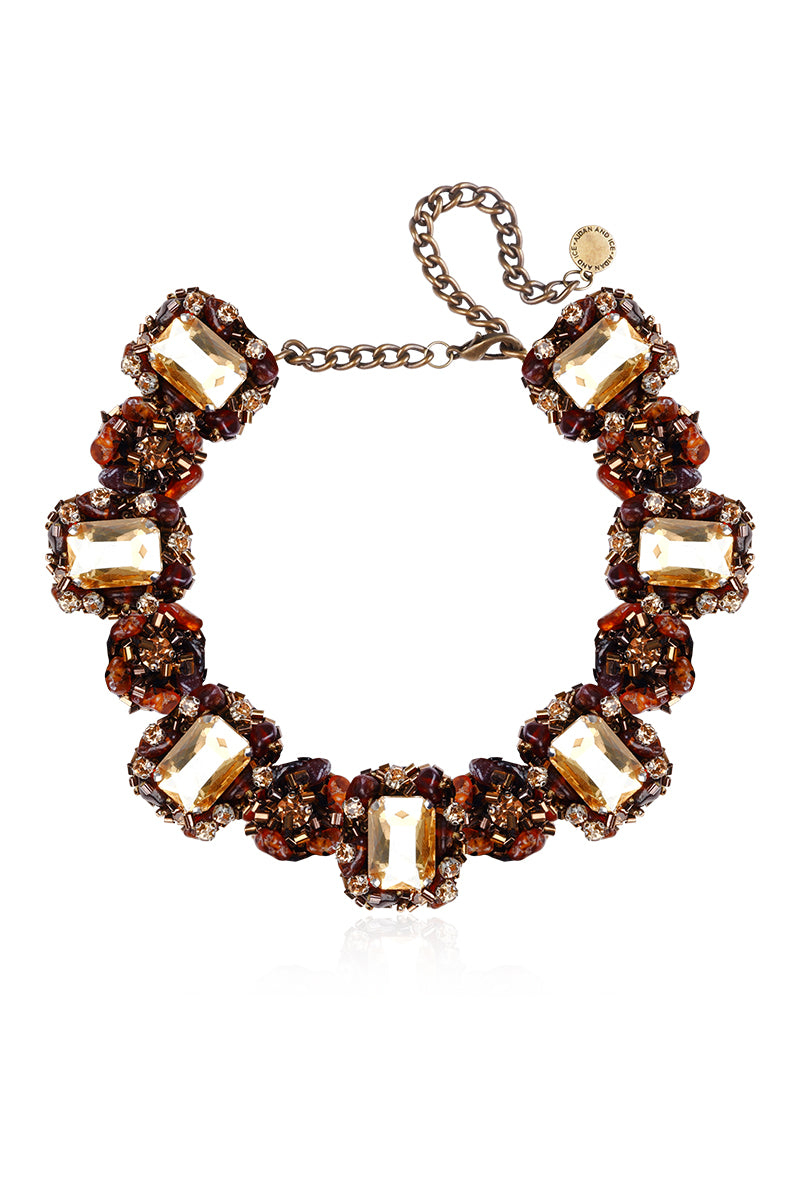 Gold Amora necklace by Aidan & Ice featuring a delicate chain and elegant pendant on a neutral background.