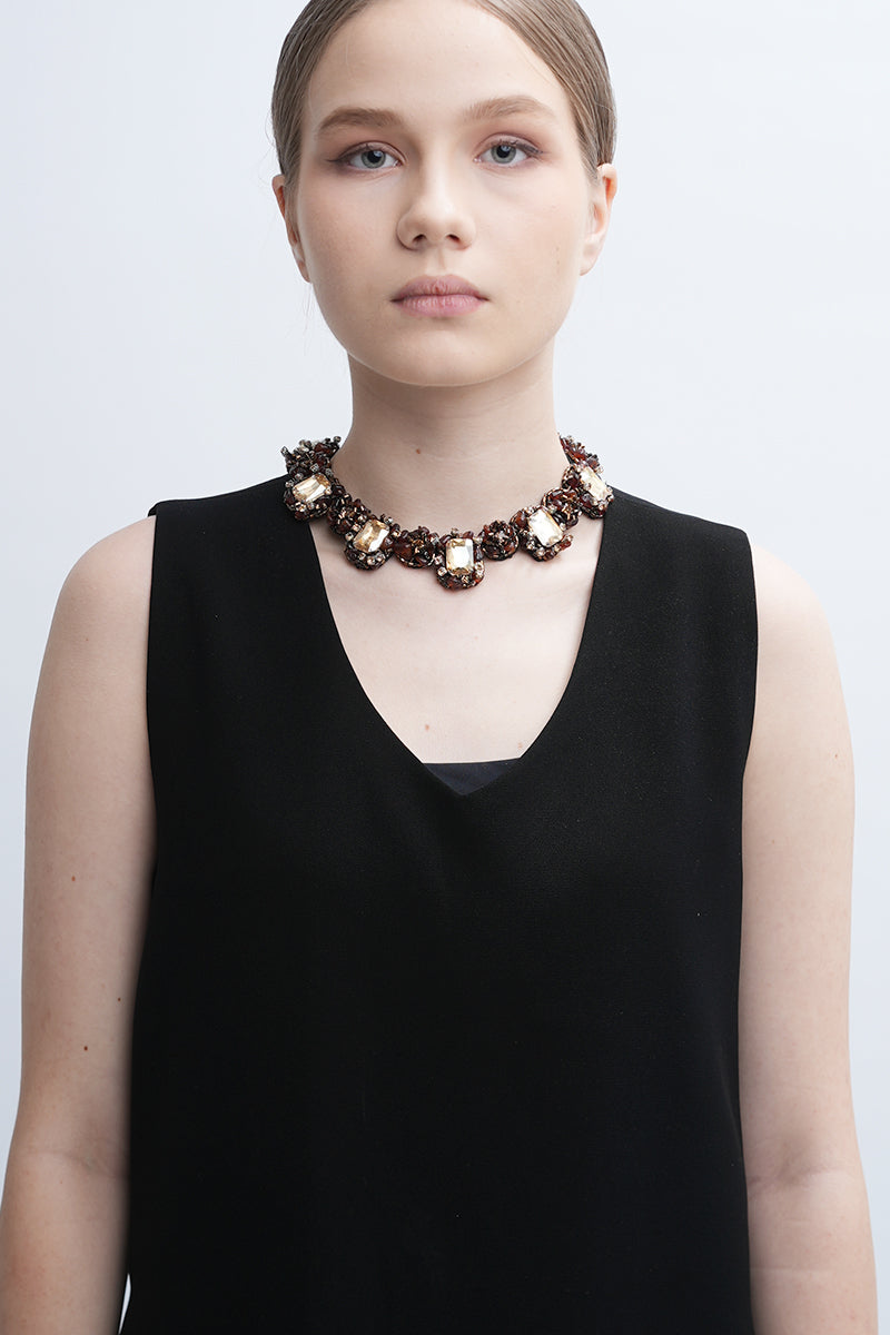 Gold Amora necklace by Aidan & Ice featuring a delicate chain and elegant pendant, displayed on a neutral background.