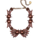 Golden Grace necklace by Aidan & Ice featuring a delicate chain and elegant pendant, showcased on a neutral background.