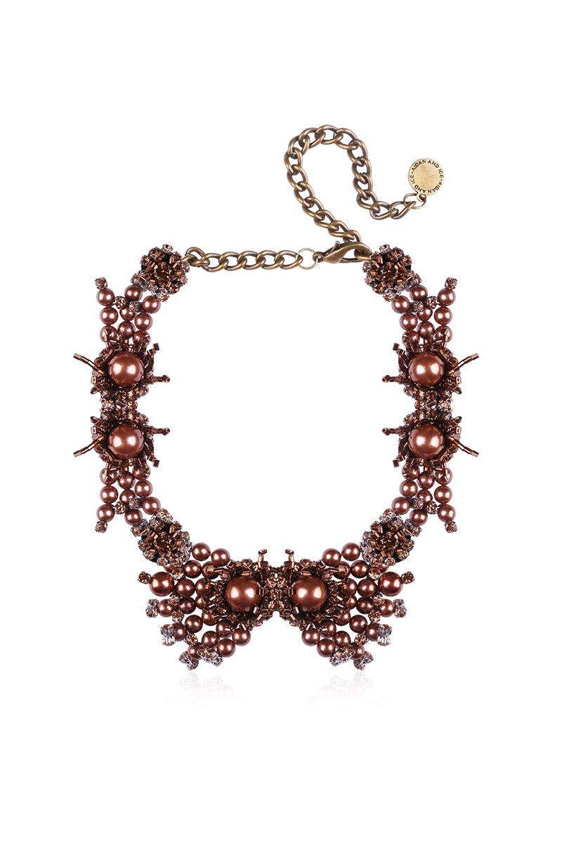 Golden Grace necklace by Aidan & Ice featuring a delicate chain and elegant pendant, showcased on a neutral background.