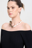 Aidan & Ice Golden Luxe Necklace featuring a delicate gold chain with an elegant pendant, worn by a model.
