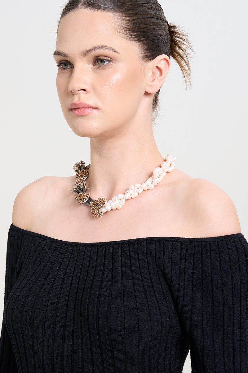 Aidan & Ice Golden Luxe Necklace featuring a delicate gold chain with an elegant pendant, worn by a model.