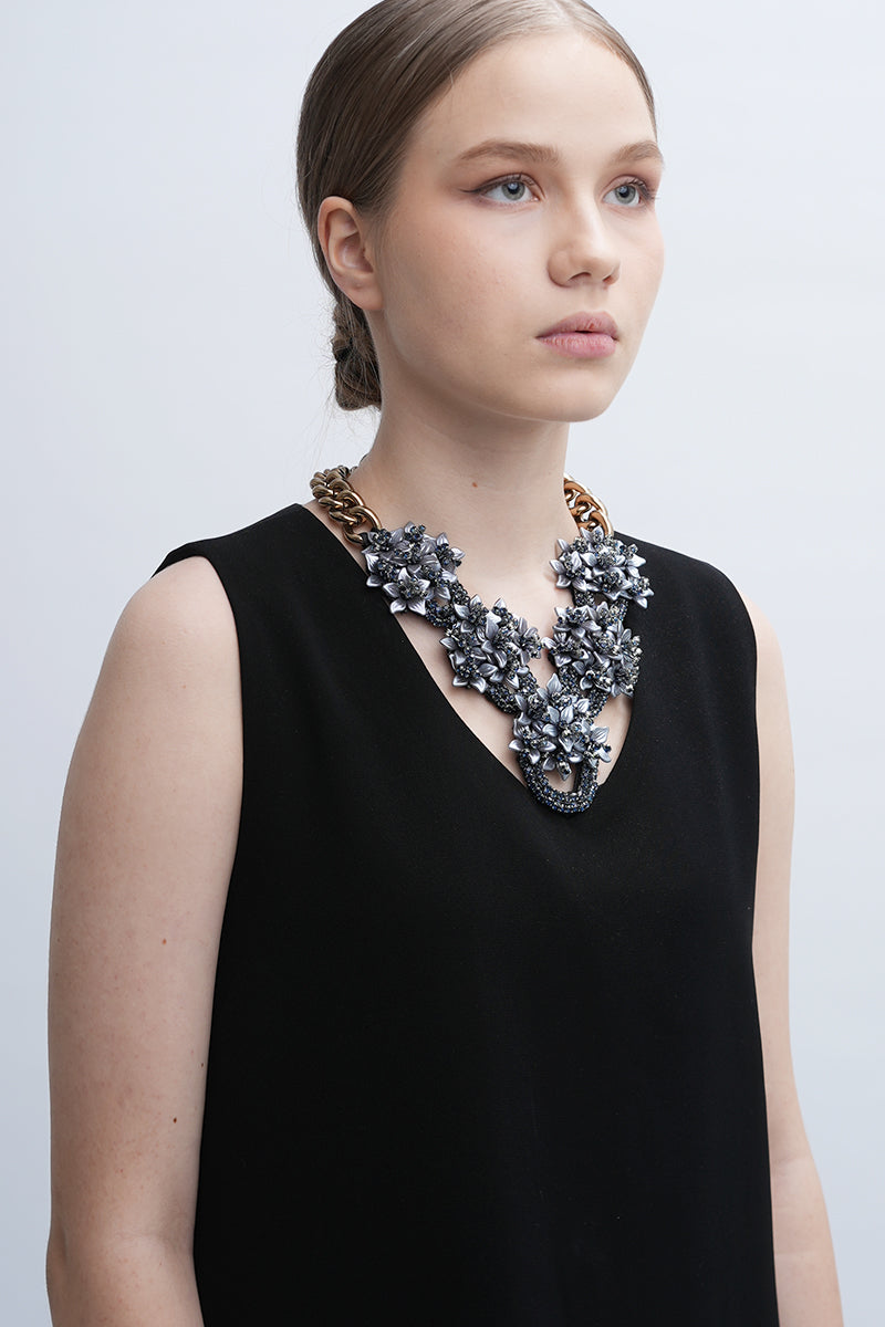 Gray Greta necklace by Aidan & Ice featuring a delicate chain and minimalist pendant on a plain background.