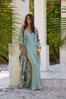 NiLuu Jade Scarlet slip dress, a stylish maxi dress with a flowing silhouette and vibrant red color, displayed on a hanger.