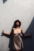 Silk chemise by NK Imode, bust-support nightgown in rose gold with delicate lace details and smooth satin finish.