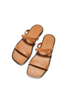 KIÓHNE NOAH tan sandals shown on a model, featuring a casual open-toe design and comfortable straps.