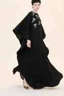 Nihan Peker NEEHAL Batwing Gown in flowing fabric with batwing sleeves, elegant design, shown on a model.