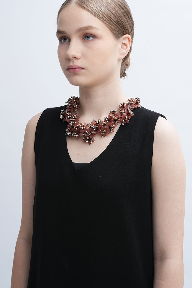 Aidan & Ice Peach Emilia Necklace featuring a delicate peach-colored pendant on a fine chain, styled for elegant wear.