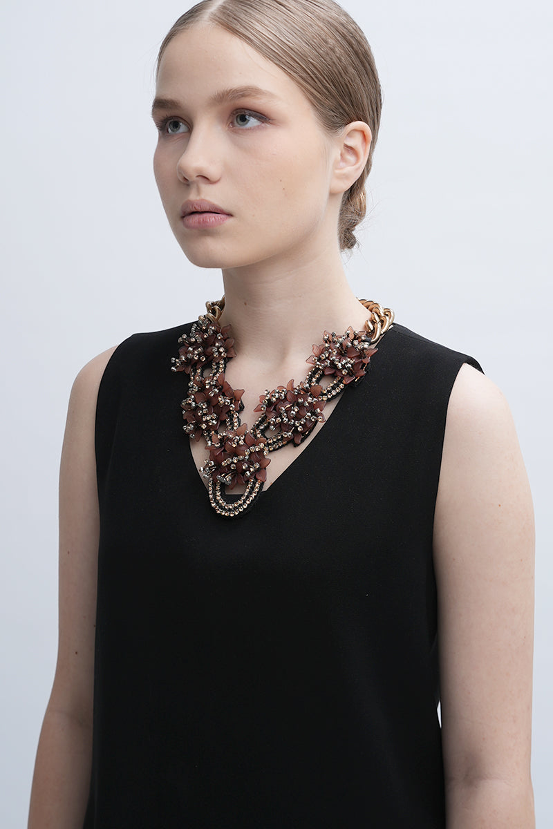 Aidan & Ice Peach Greta necklace with a delicate peach-colored pendant on a fine chain, stylish and elegant jewelry accessory.