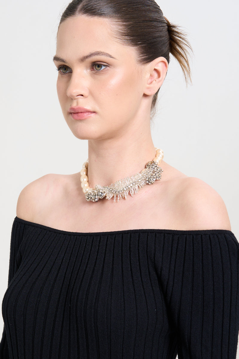 A model wearing the Pearls Dream Necklace by Aidan & Ice, featuring a delicate pearl necklace with elegant design.