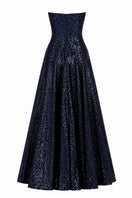 Nihan Peker Vertigo strapless gown in elegant fabric, featuring a fitted bodice and flowing skirt, displayed on a model.