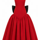 Elegant red gown by Nihan Peker, featuring flowing fabric and sophisticated design, perfect for formal occasions.