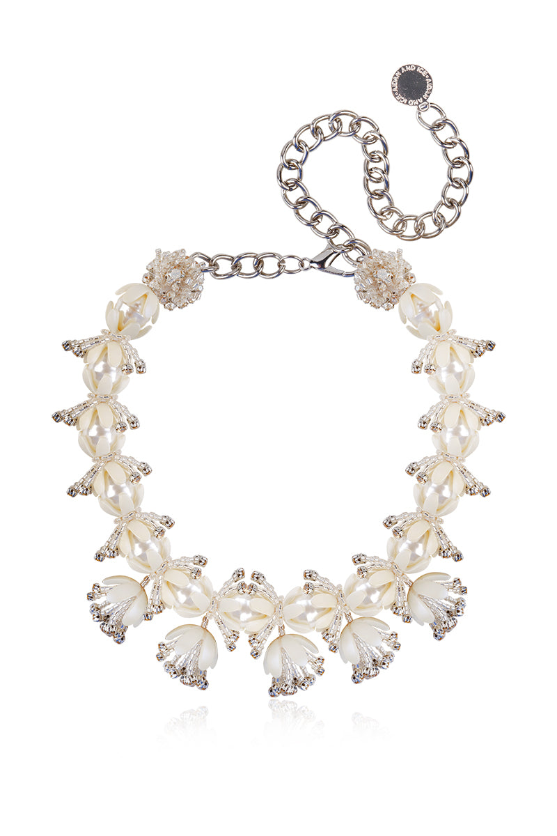 Aidan & Ice Solace white necklace featuring a delicate chain and minimalist pendant on a neutral background.