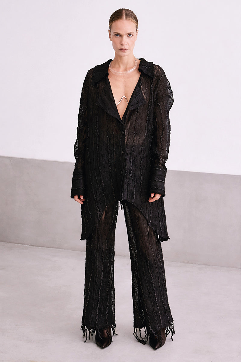 Cream lace culotte trousers by MAZ Manuela Álvarez featuring delicate lace fabric and wide-leg design.