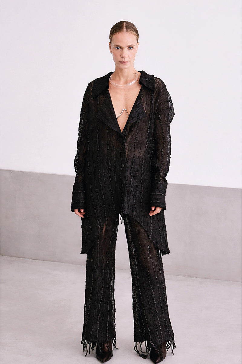 Maz Manuela Álvarez NUNO mesh felt shirt displayed on a hanger, showcasing its lightweight, textured fabric and stylish design.