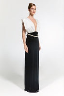 Nur Karaata Ciragan Palace gown featuring elegant fabric and intricate design, showcased on a model in a luxurious setting.