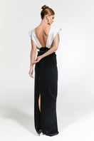 Elegant Nur Karaata Ciragan Palace gown displayed on a mannequin with intricate detailing and flowing fabric.