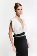 Elegant Nur Karaata Ciragan Palace gown with intricate embroidery and flowing fabric, displayed on a mannequin.