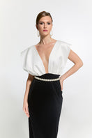 Nur Karaata Ciragan Palace gown displayed on a model, featuring elegant fabric and intricate design for formal occasions.