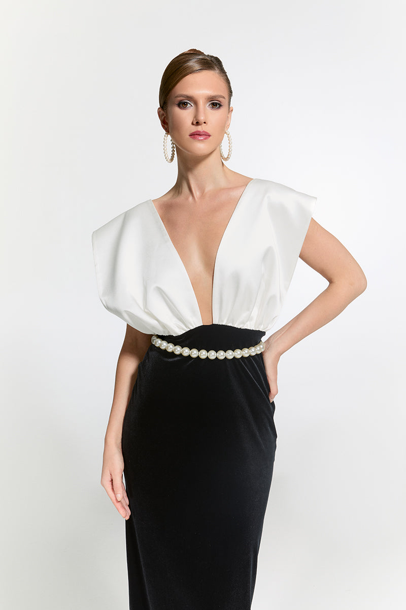 Nur Karaata Ciragan Palace gown displayed on a model, featuring elegant fabric and intricate design for formal occasions.