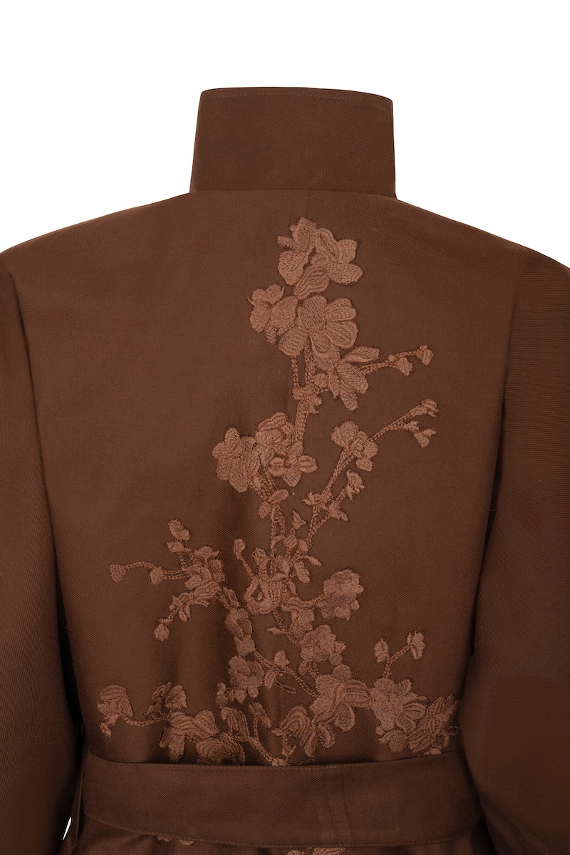 Nadya Shah Mocha Rose Detail Coat displayed on a hanger, showcasing its stylish design and textured fabric.