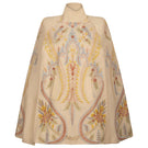 Ivory DORIAN cape jacket by Nadya Shah, shown on a model, featuring elegant draping and stylish design.