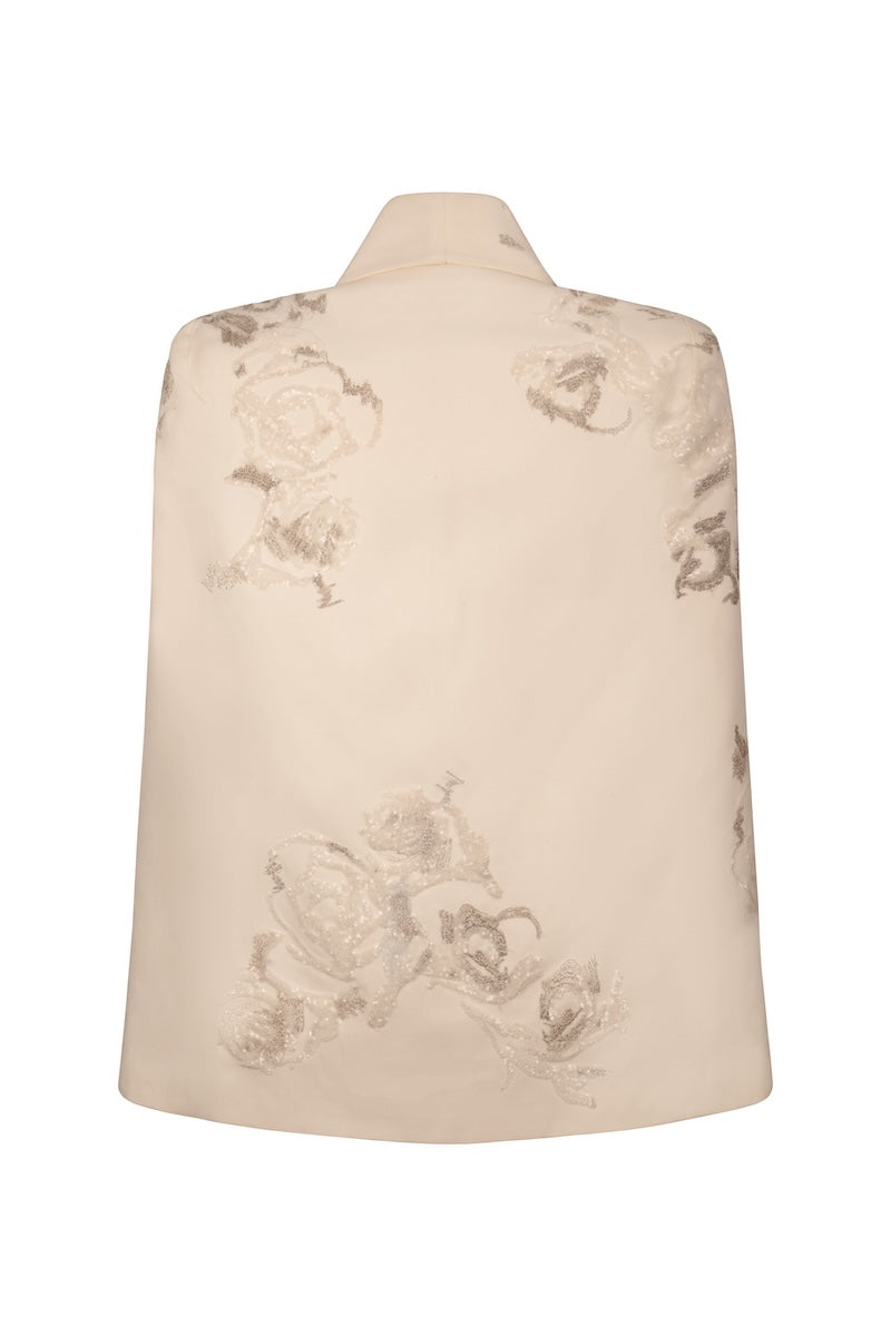 Nadya Shah Lumiere Cape jacket featuring luxurious fabric and elegant design, shown draped on a mannequin.