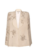 Nadya Shah Lumiere Cape jacket featuring elegant fabric and stylish design, displayed on a hanger with a neutral background.