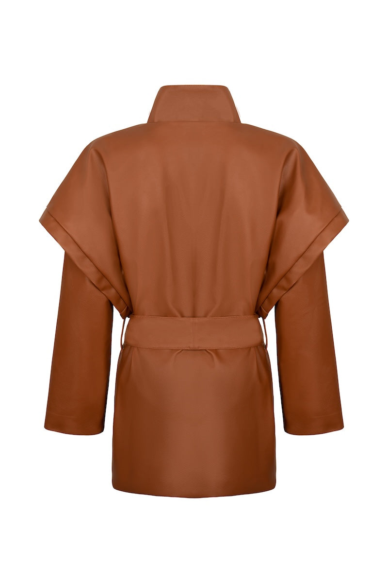 Nadya Shah CLEO faux leather belted jacket displayed on a hanger, featuring a sleek design with a waist belt and classic collar.