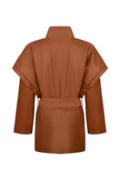Nadya Shah CLEO faux leather belted jacket displayed on a hanger with a sleek, fitted design and stylish belt detail.