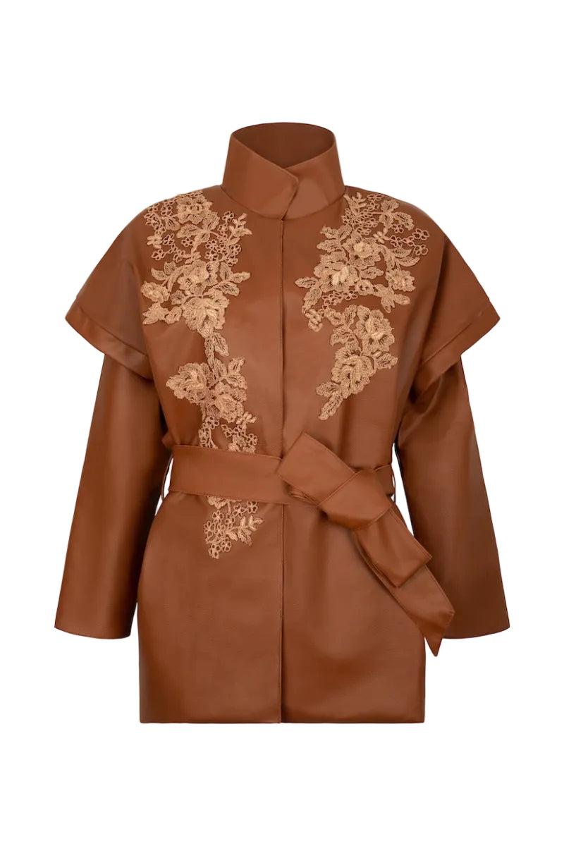 Nadya Shah CLEO faux leather belted jacket displayed on a hanger, featuring a sleek design with a waist belt and stylish collar.