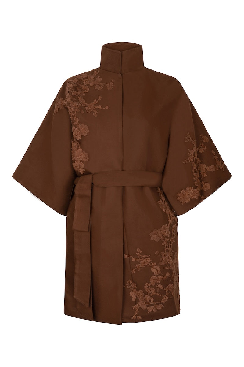 Nadya Shah mocha rose detail coat with floral accents, stylish outerwear for women, shown on a model.