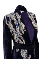 Manal midnight blue velvet smoking jacket by Nadya Shah, featuring luxurious fabric and classic design, displayed on a hanger.