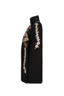 Nadya Shah Gaia Black Wisteria Cape jacket with flowing fabric and floral wisteria design on a black outer layer.