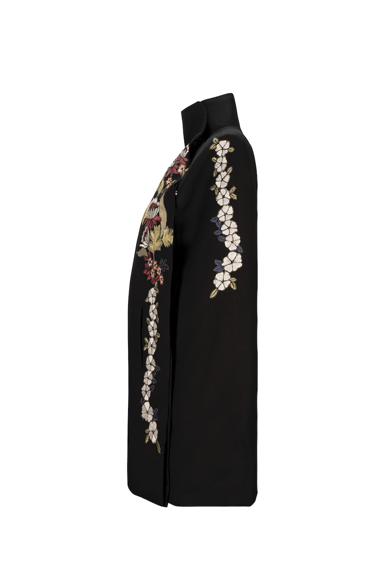 Nadya Shah Gaia Black Wisteria Cape jacket with flowing fabric and floral wisteria design on a black outer layer.
